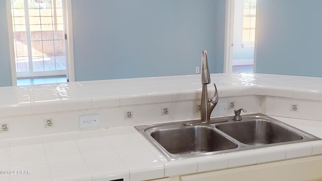 interior details with tile counters and sink