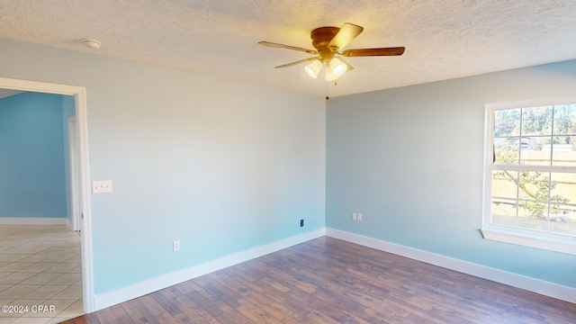 spare room featuring hardwood / wood-style floors, a textured ceiling, and ceiling fan