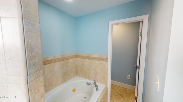 bathroom with tile patterned floors, a washtub, and a textured ceiling