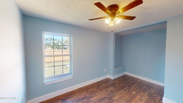 spare room featuring a textured ceiling, dark hardwood / wood-style floors, and ceiling fan