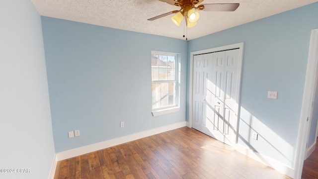 empty room with wood-type flooring, a textured ceiling, and ceiling fan