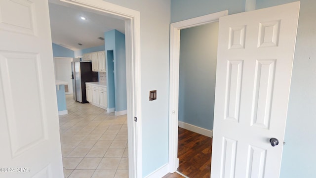 corridor with light hardwood / wood-style floors