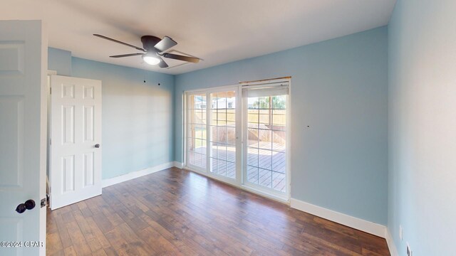 spare room featuring ceiling fan and dark hardwood / wood-style flooring