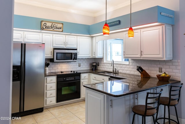 kitchen with black appliances, white cabinets, kitchen peninsula, and sink