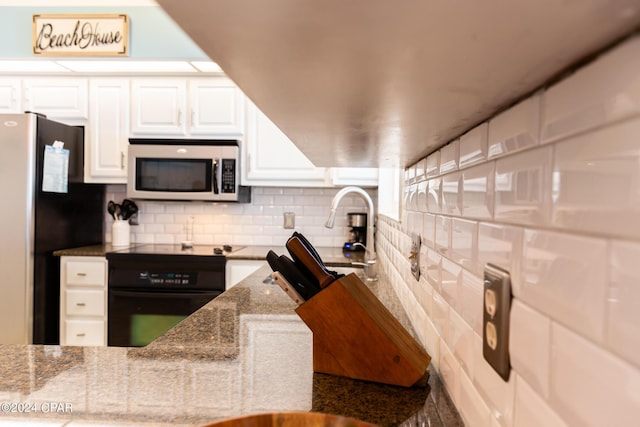 kitchen featuring white cabinets, decorative backsplash, stone countertops, and stainless steel appliances