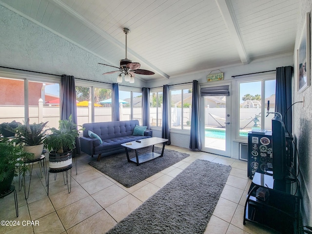 sunroom / solarium with ceiling fan and beam ceiling