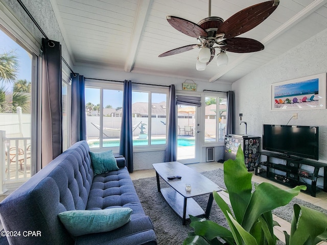 sunroom featuring vaulted ceiling with beams and ceiling fan