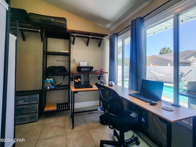 tiled office with ornamental molding and vaulted ceiling