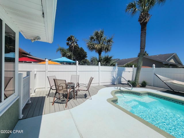 view of swimming pool with a wooden deck