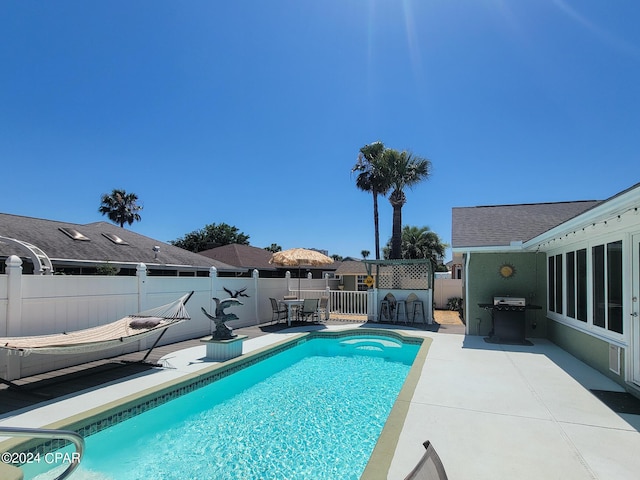 view of pool featuring a patio and grilling area