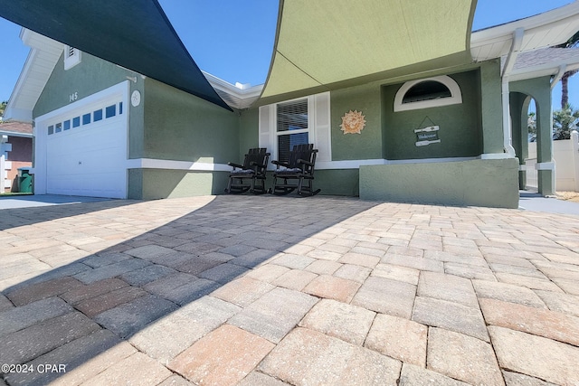 view of patio featuring a garage