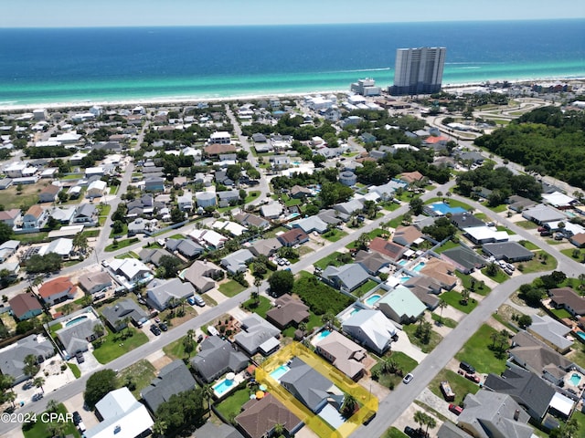 birds eye view of property featuring a beach view and a water view