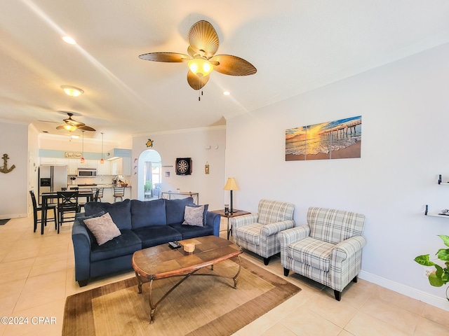 living room with ceiling fan, light tile patterned flooring, and crown molding