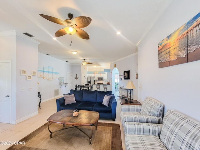 tiled living room featuring ceiling fan and crown molding