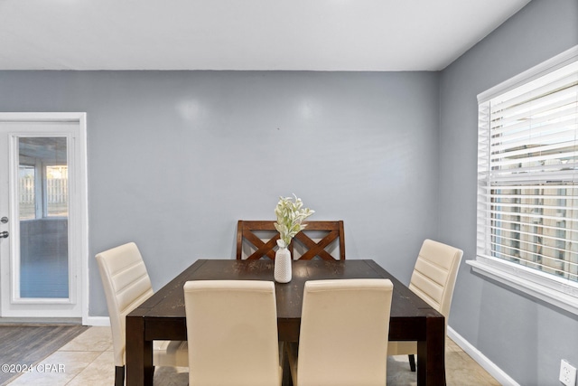 dining space featuring light tile patterned floors