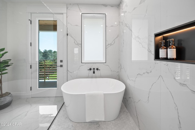 bathroom featuring a tub and tile walls