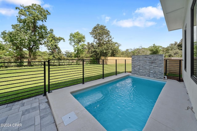 view of swimming pool with a fenced in pool, a lawn, and fence