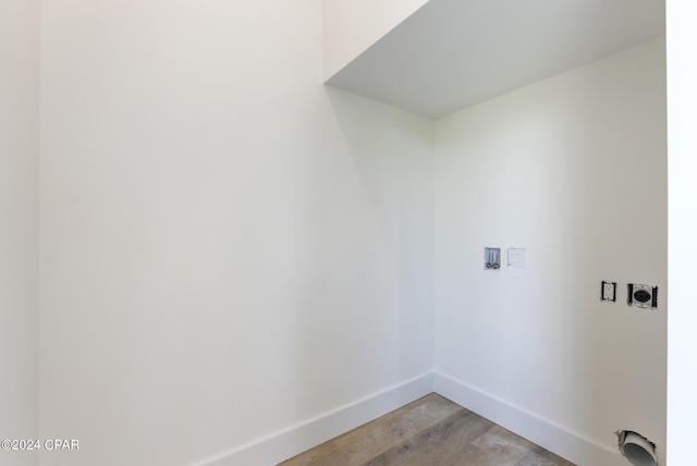 washroom featuring hookup for an electric dryer, hookup for a washing machine, and light wood-type flooring