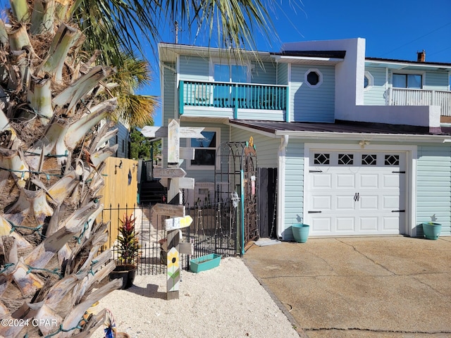 view of front facade with a balcony and a garage