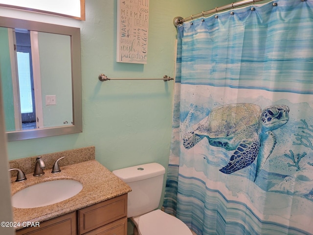 bathroom featuring walk in shower, vanity, toilet, and plenty of natural light