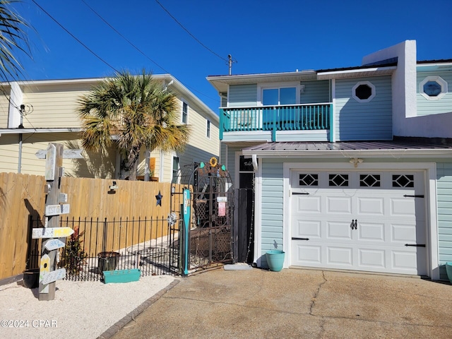 view of front of home with a balcony and a garage