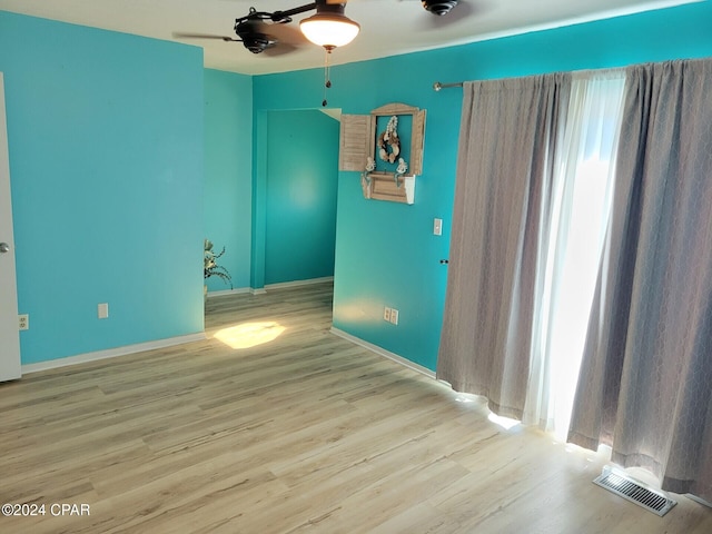 empty room featuring ceiling fan and light hardwood / wood-style floors