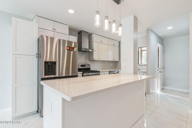 kitchen with appliances with stainless steel finishes, wall chimney exhaust hood, pendant lighting, a center island, and white cabinetry