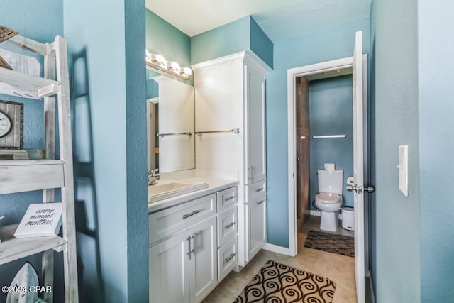 bathroom with tile patterned floors, vanity, and toilet