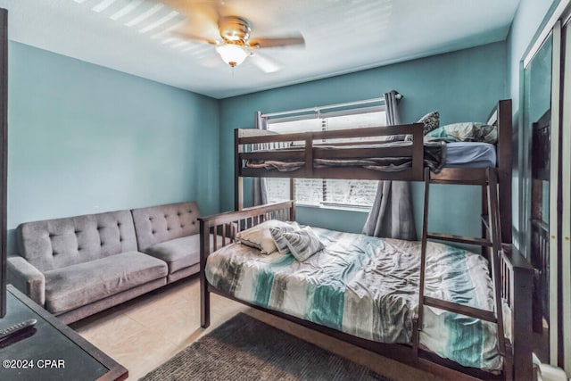 tiled bedroom featuring ceiling fan