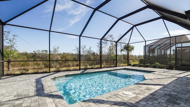 view of pool featuring a lanai and a patio