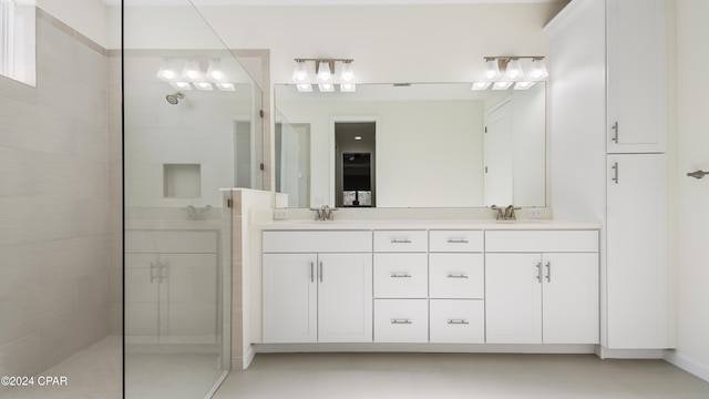 bathroom featuring vanity and tiled shower