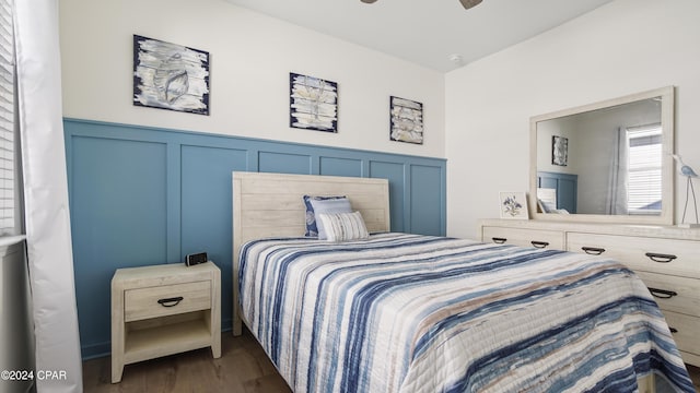 bedroom with ceiling fan and dark hardwood / wood-style flooring