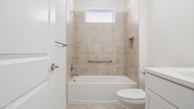 full bathroom featuring tile patterned floors, vanity, toilet, and tiled shower / bath combo