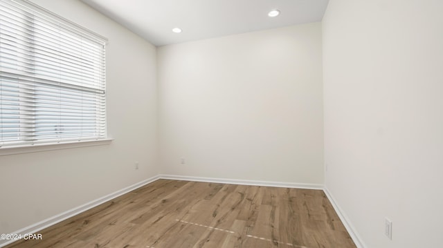 spare room featuring light hardwood / wood-style floors