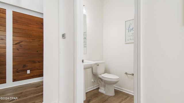 bathroom with wood-type flooring and toilet