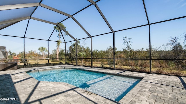 view of swimming pool featuring a lanai and a patio area