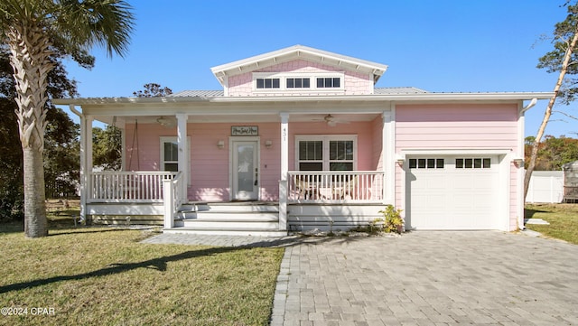 view of front of home featuring a porch, a garage, and a front yard