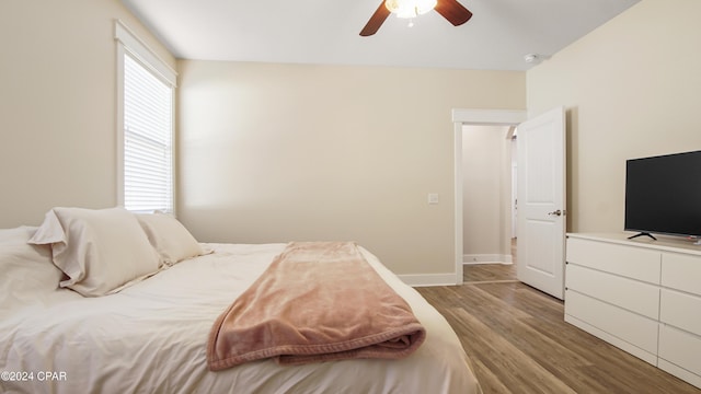 bedroom with ceiling fan and light wood-type flooring