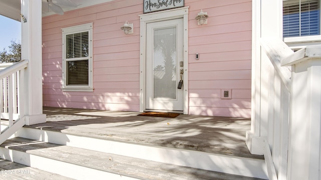 doorway to property featuring ceiling fan and covered porch