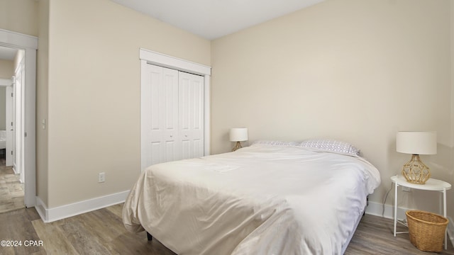 bedroom featuring hardwood / wood-style floors and a closet