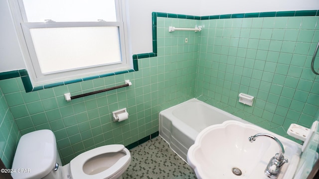 bathroom featuring toilet and tile walls