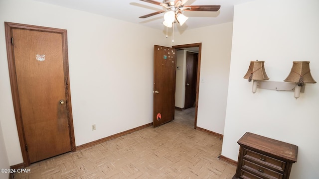 empty room featuring ceiling fan and light parquet flooring