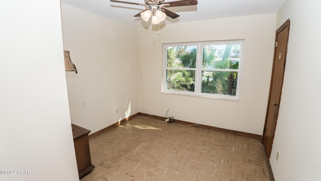 unfurnished room with ceiling fan and light parquet floors