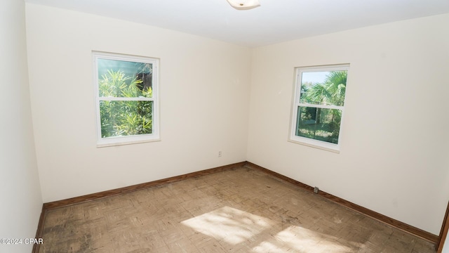 unfurnished room with light parquet flooring