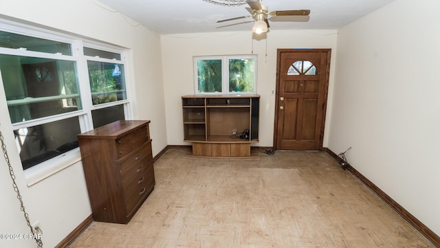 foyer entrance with ceiling fan and light hardwood / wood-style floors