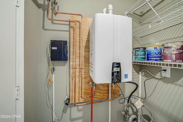 utility room with tankless water heater