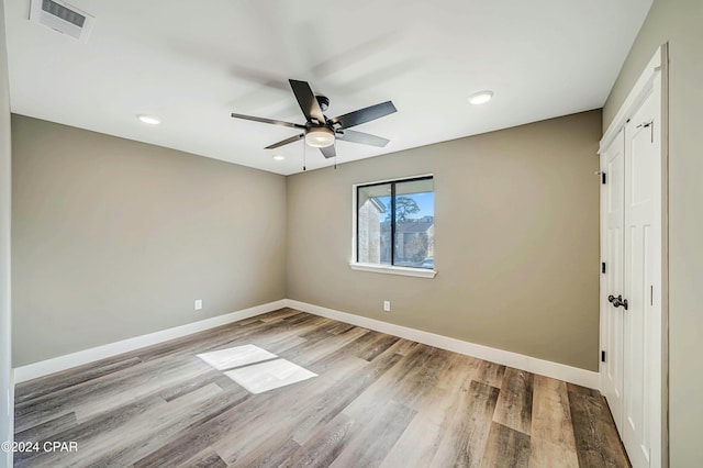 empty room featuring ceiling fan and light hardwood / wood-style flooring