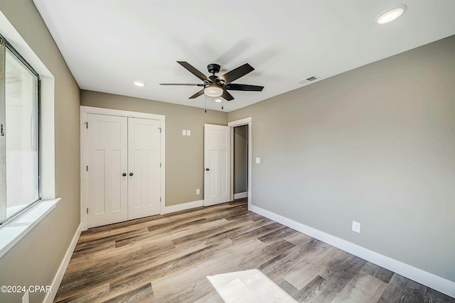 unfurnished bedroom featuring ceiling fan and light hardwood / wood-style flooring