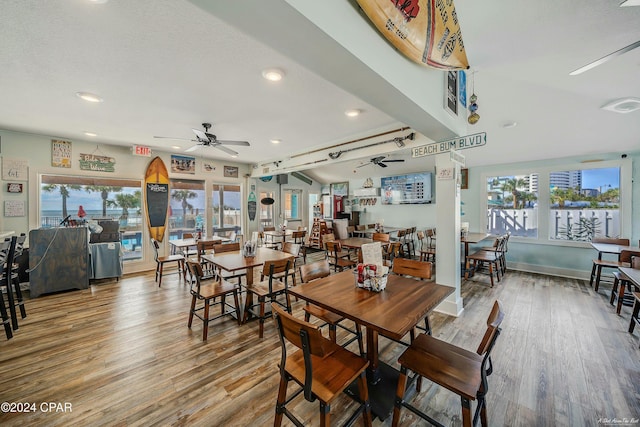 dining room featuring hardwood / wood-style floors, ceiling fan, and plenty of natural light