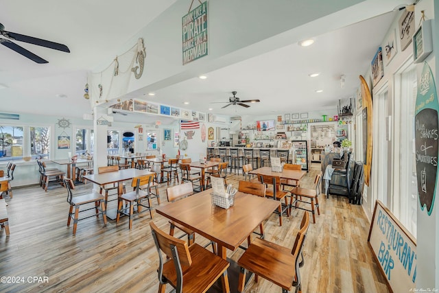 dining space with ceiling fan and light wood-type flooring